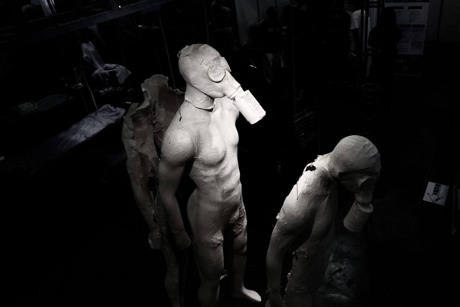 Unveiled State — winged figure with gas mask sculpture installation by Lei Shi